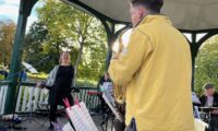 King Groovy plan on Ruskin Park Bandstand, in October 2022. The singer and alto sax player are having a ball!